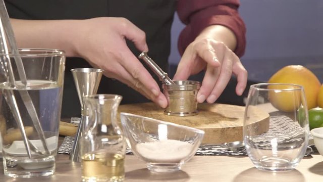 putting the jar with muddler on the chopping board - panning