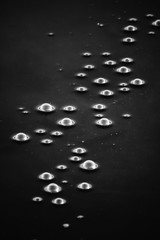 white bubbles in black water