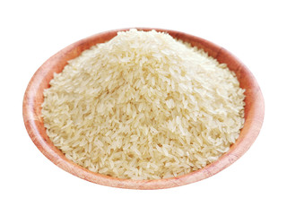 Parboiled rice on a bamboo bowl isolated on white background.  Selective focus.