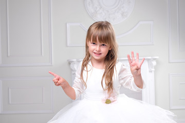 girl in a white dress laughs hand gestures