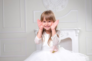 girl in a white dress laughs hand gestures