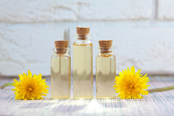 dandelion essential oil in  beautiful bottle on White background