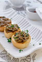 Pate on toast baguette slices with liver and thyme. Close-up.

