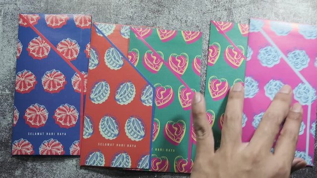 Money envelope with Malaysia ringgit money insight for "duit raya" concept. "Selamat Hari Raya" in English is Happy Eid Mubarak.
