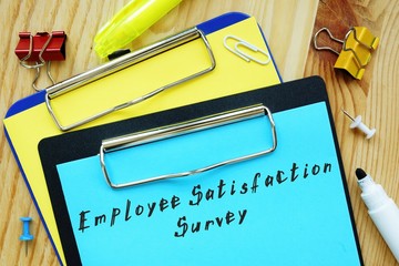 Business concept meaning Employee Satisfaction Survey with phrase on the piece of paper.