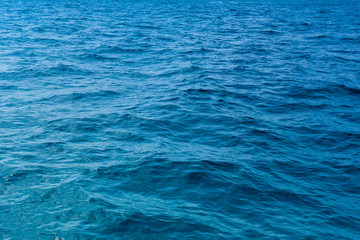 Naklejka na ściany i meble Water texture,Surface blue sea water. Texture of water with small waves,Water surface background 
