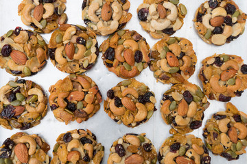 Cookies with nuts Almonds, Pumpkin seeds, Melon seeds, Cashews, Dried Raisins ,Sunflower Seed,Cranberry,white and black sesame on tray.vegan food