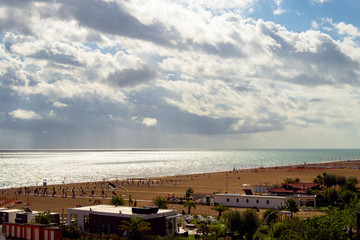 mediterranean italian beach with sand and parasols