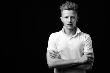Punk rocker man with arms crossed in black and white