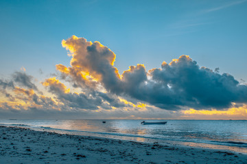 Sun Rise in May in Nyali, Mombasa. The Sun is hidden by the clouds forming a golden lining
