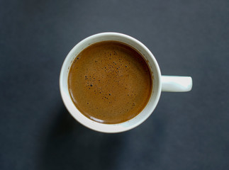 Cup of coffee on a dark background. Dark grey background. Flat lay