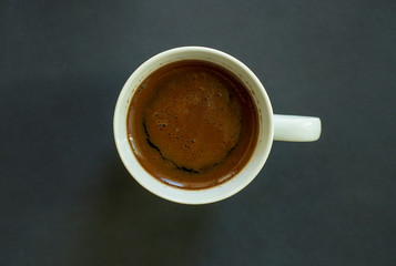 Cup of coffee on a dark background. Dark grey background. Flat lay