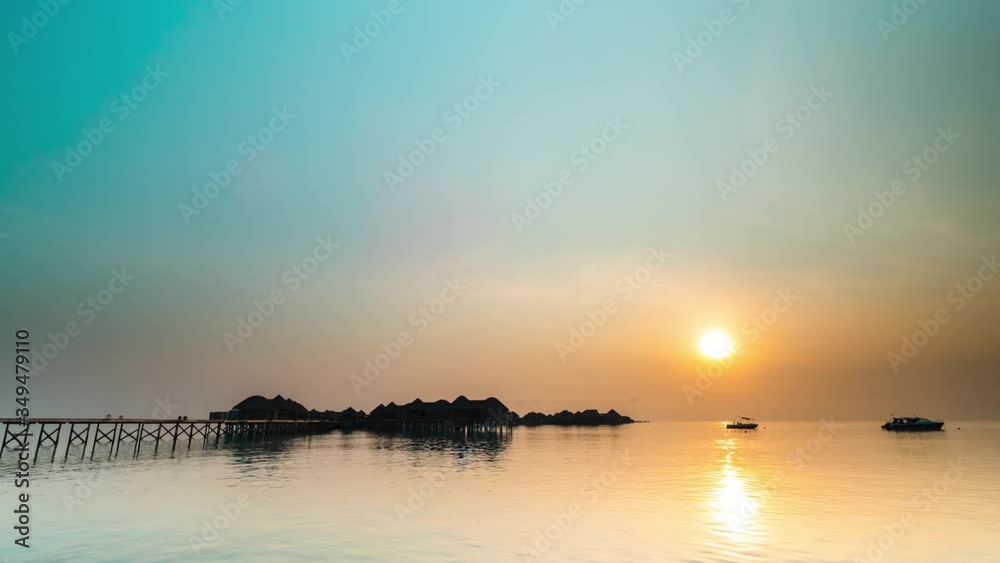 Wall mural 4K Timelapse, Maldives sunset over the calm water