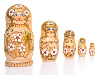 Set of five wooden matryoshka dolls standing in a row, from large to small isolated on a white background