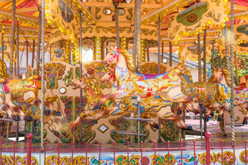 Close-up of a colorful carousel with horses to make a merry go round ride