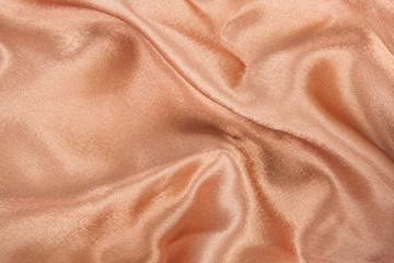 brown gold satin fabric texture curve background, soft focus.