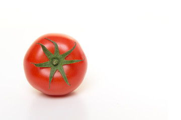 Single real tomatoe seen at its top isolated on a white background