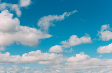 white clouds in a blue sky. Bright day, horizontal photography