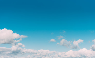 white clouds in a blue sky. Bright day, horizontal photography