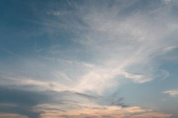 Obraz premium Sunset cloudy blue sky with the orange sun