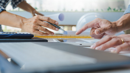 Cooperation Corporate designers in the office are working on a new project Planning blueprint Design at construction site at desk in office.