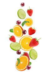 Set of different cut fresh fruits and berries falling on white background