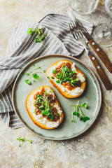 Canape or crostini with toasted baguette, cottage cheese, fig jam