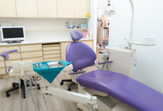 picture of dental clinic including computer operating lamp light dental tools and equipment and adjustable bed. dentistry and healthcare concept