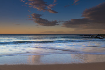 Fototapeta na wymiar Reflections and Sunrise at the Seaside