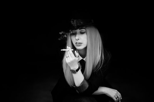 Elegant woman smoking, cinema style, artistic commercial photo for some campaign