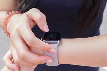 Close up the woman change music playlist with her smartwatch.