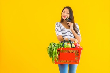 Portrait beautiful young asian woman with basket grocery and cart from supermarket