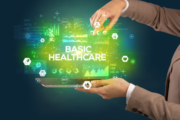 Obraz premium Close-up of a touchscreen with BASIC HEALTHCARE inscription, medical concept