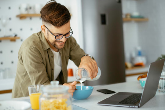 Handsome Man Eating Breakfast At Home. Happy Man Enjoying In Morning.