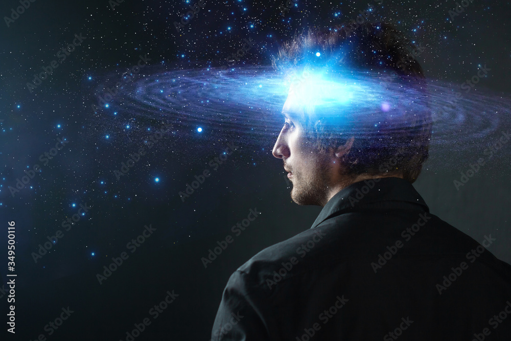 Wall mural thoughtful young man, creative mind concept. a man with a galaxy in his head,