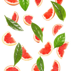Slices of juicy grapefruit and leaves on white background