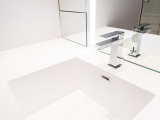 Faucet and white washbasin in the bathroom.