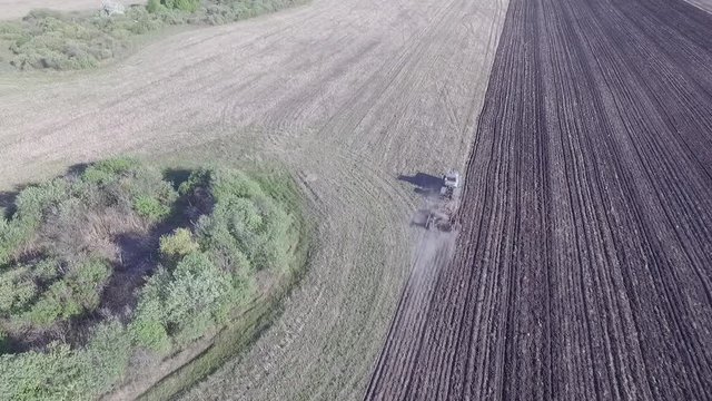 spring plowing, tractors plow the field after winter