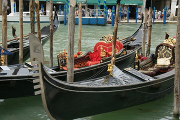 Fototapeta na wymiar Photo of gondolas in Venice with green water of Grand canal in summer.