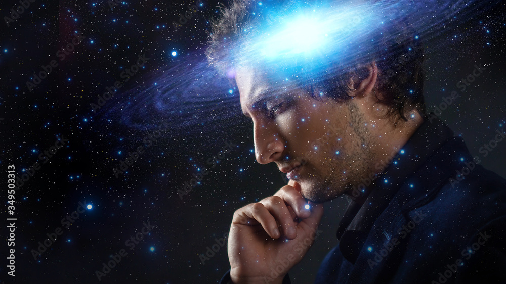 Wall mural thoughtful young man, creative mind concept. a man with a galaxy in his head,