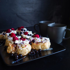 Cinnamon rolls with berries and whipped cream