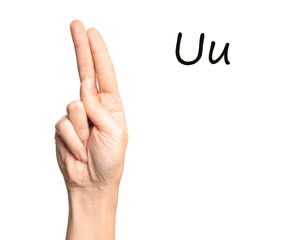 Woman showing letter U on white background, closeup. Sign language