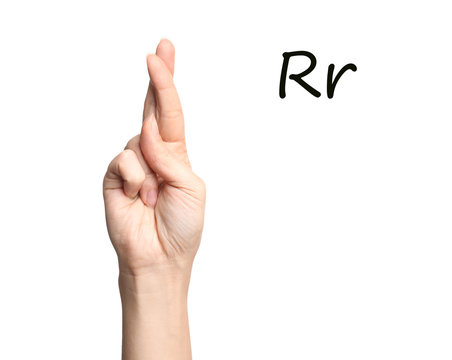 Woman showing letter R on white background, closeup. Sign language