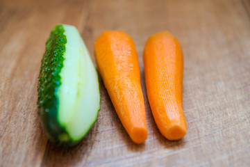 cucumber and carrots. Peeled healthy vegetables. healthy eating for breakfast. Wood background