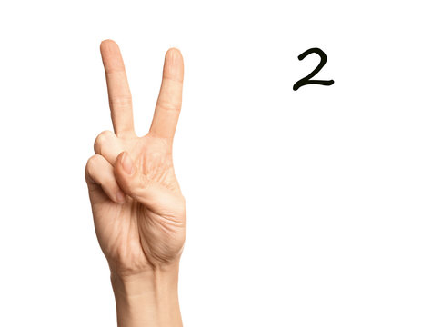 Woman showing number two on white background, closeup. Sign language