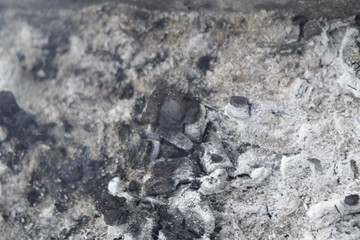 Gray ashes from burning coals.