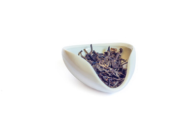 Shen PU'er in a white bowl cha he loose Yunnan Bai Cha isolated on a white background close-up