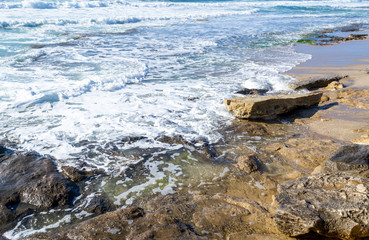 Rocky shore in Castelsardo on a sunny day.
