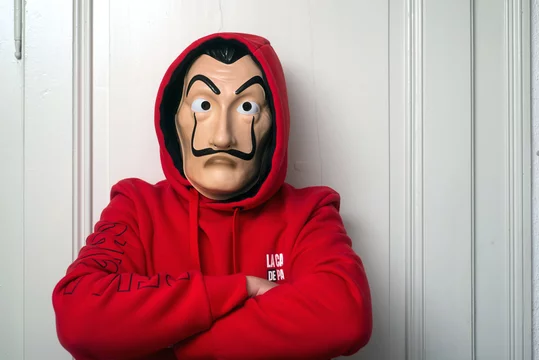 Mulhouse - France - May 16 2020 : Portrait of fan of the serie tv "La casa  de papel (paper house) traduction in english on Netflix standing with red  sweat shirt costume