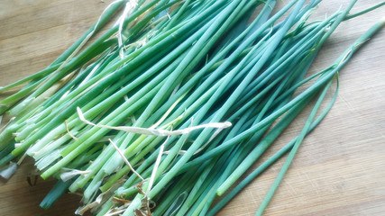 Bunch of newly harvested spring onions on the table.